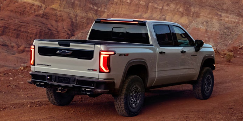 Rear view of a white 2027 Chevy Silverado 1500 ZR2 on a desert trail