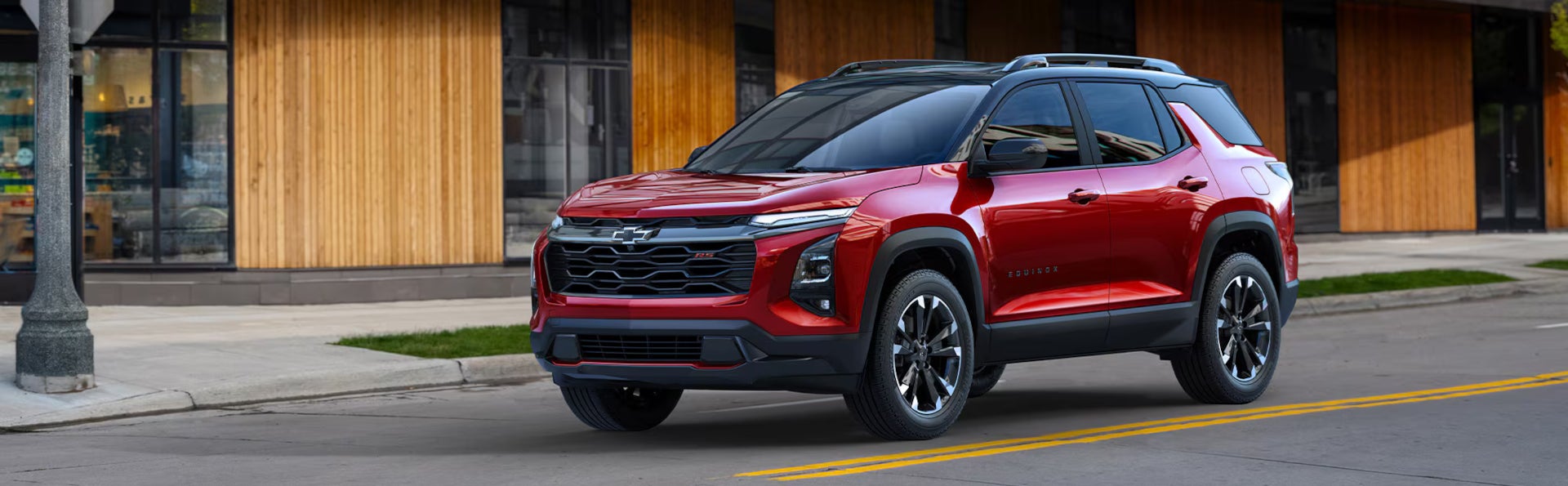 A red Chevrolet Equinox driving in a city