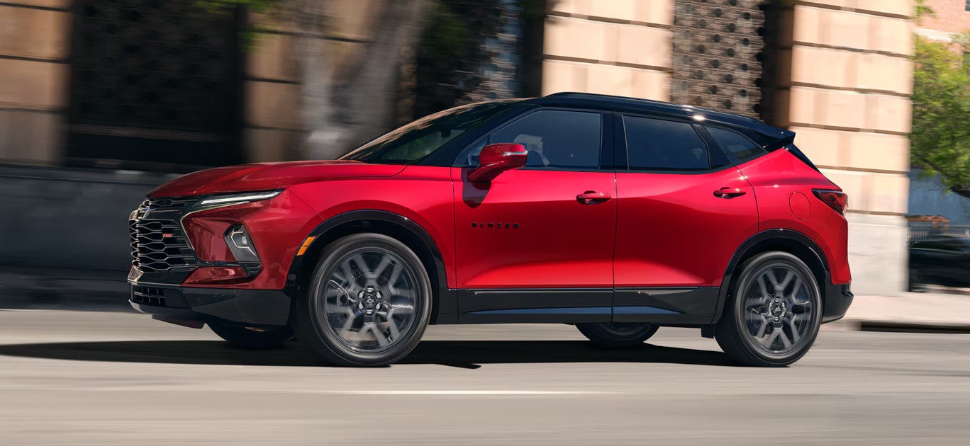 Image of a red Chevrolet Blazer midsize SUV driving in a city