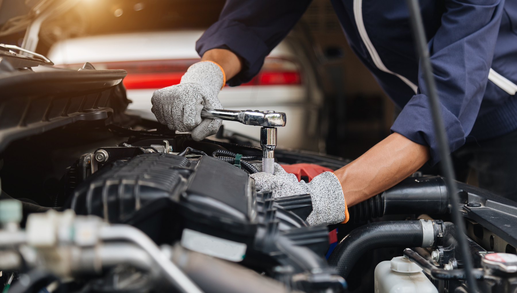 Certified Chevrolet service technicians working on a vehicle in a service bay